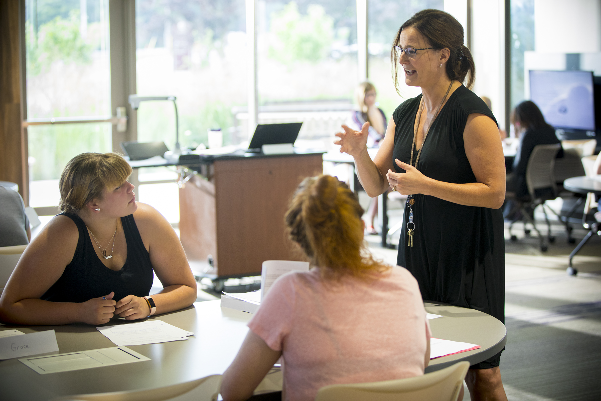 Teacher lecturing students in lab