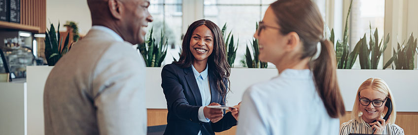 Hospitality Worker smiling at their clients