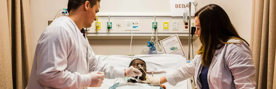 Two students working with mannequin 