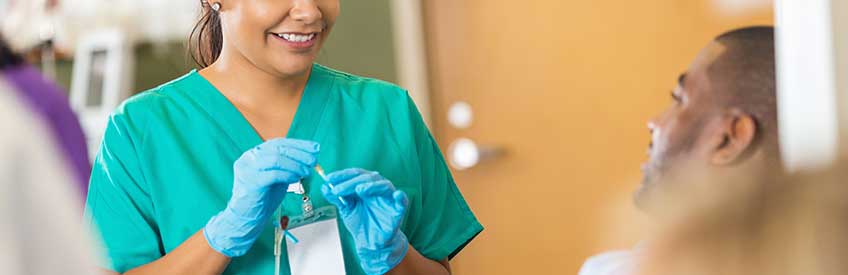 Phlebotomy technician working with patient 